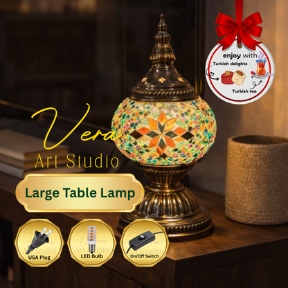 Decorative table lamp with mosaic design on a wooden surface, featuring Vera Art Studio branding.